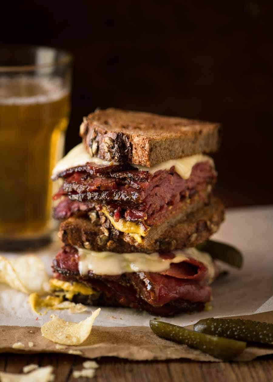 Easy Homemade Pastrami sandwich cut in half, stacked on top of each other.