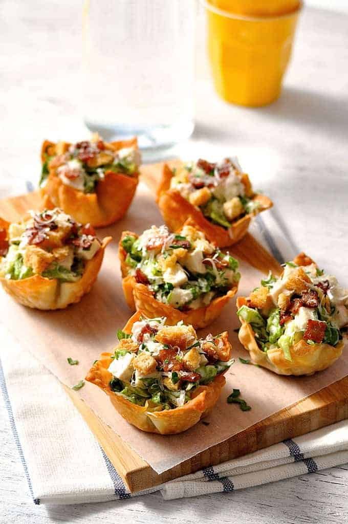 Caesar Salad Wonton Cups on a wooden board
