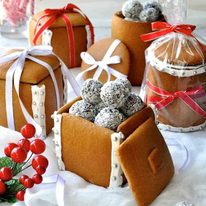 Festive spread of Gingerbread Boxes and Mason Jars tied with ribbons and filled with chocolate truffle balls.