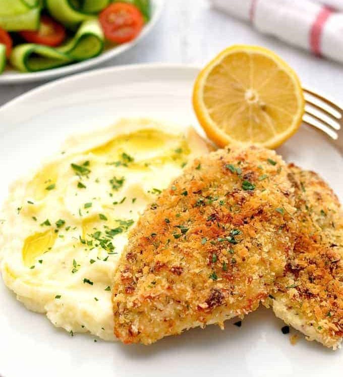 Super Quick Chicken Dinner of crunchy broiled / grilled chicken, mashed potato and side salad on a white plate, ready to be eaten.
