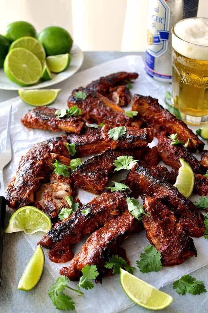 A tray of Oven Baked Ribs with Chipotle Barbecue Sauce scattered with cilantro