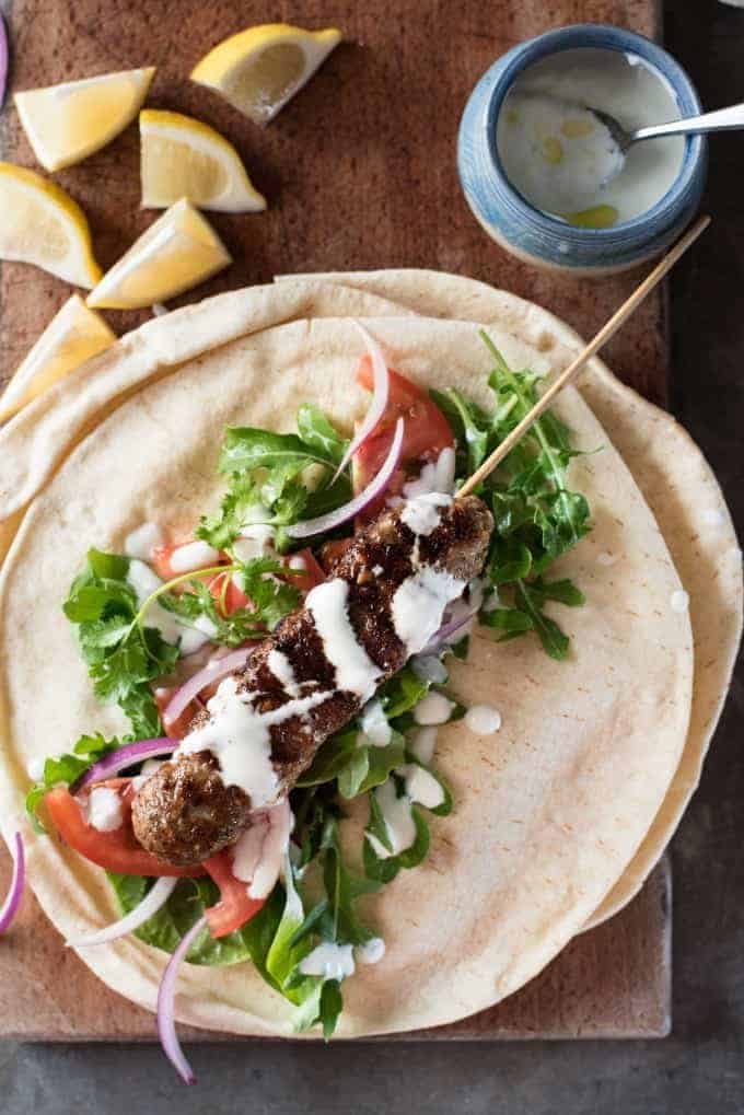Turkish Lamb Kebab Kofta on pita with vegetables and yoghurt sauce