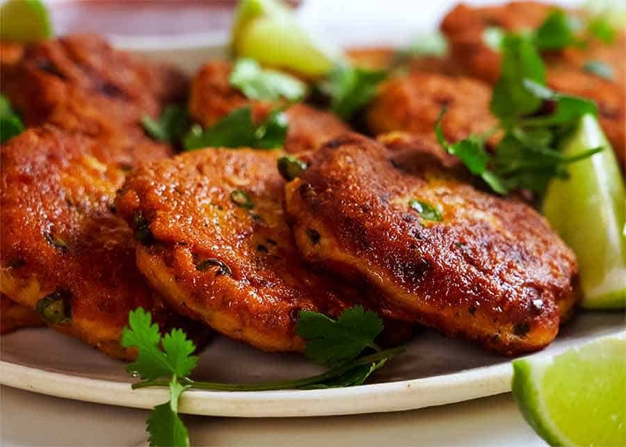 Close up of golden Thai Fish Cakes on a plate