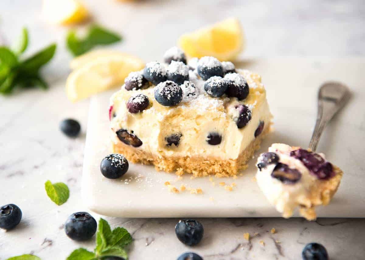 These Blueberry Cheesecake Bars are light yet creamy and luscious. Filled with soft blueberries, this is a baked cheesecake that's so easy to make! www.recipetineats.com