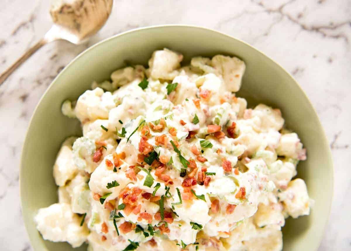 A classic potato salad made epic by pouring French dressing over the potatoes while cooked so it absorbs the flavour. The BEST potato salad I've ever had! www.recipetineats.com