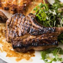 Overhead photo of Grilled chops on a plate with potato rosti and salad, made using amade using a great Pork Chop Marinade
