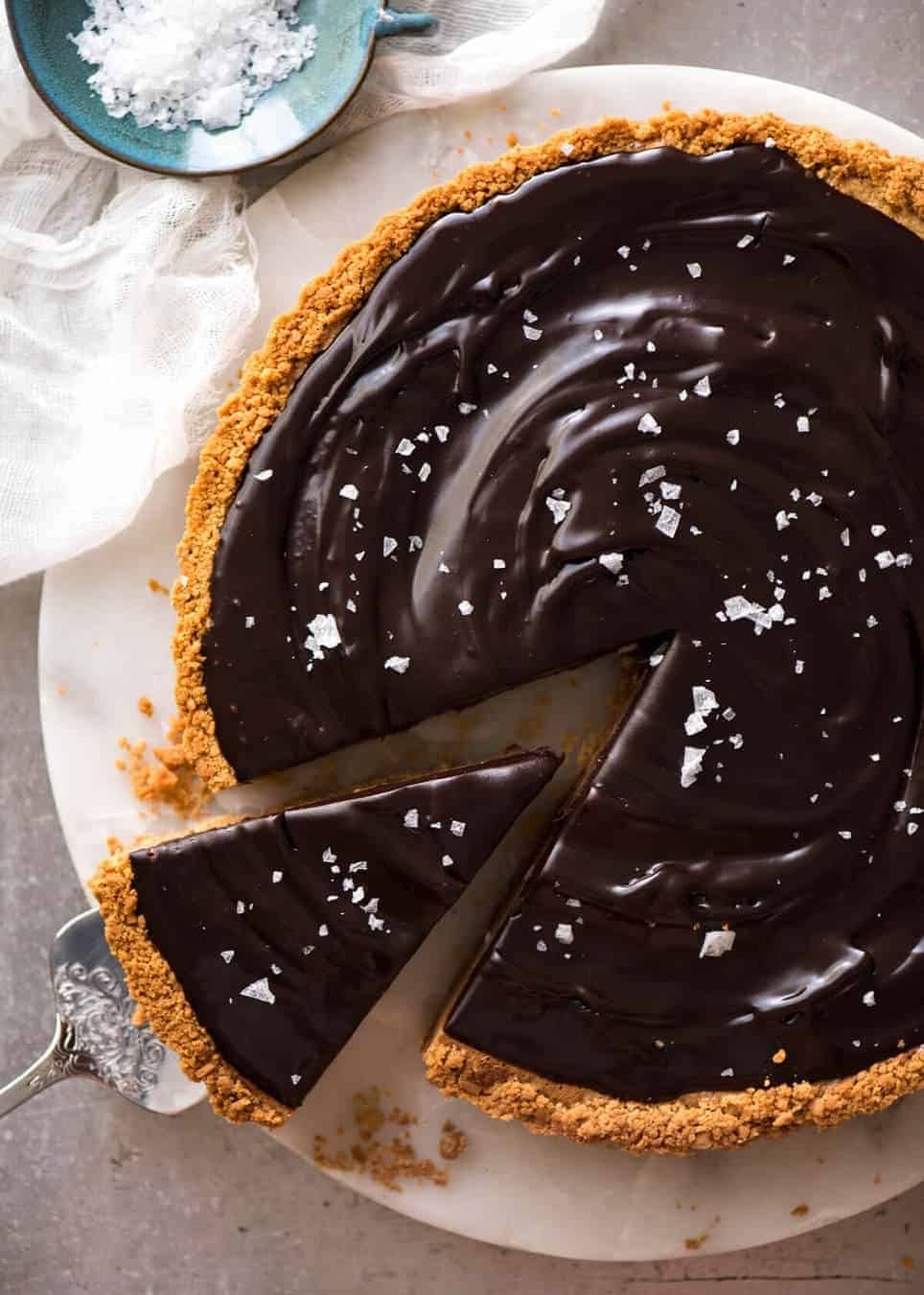 A sinfully decadent Salted Caramel Tart with a creamy soft salted caramel filling topped with luxurious chocolate ganache. Just SIX ingredients! www.recipetineats.com