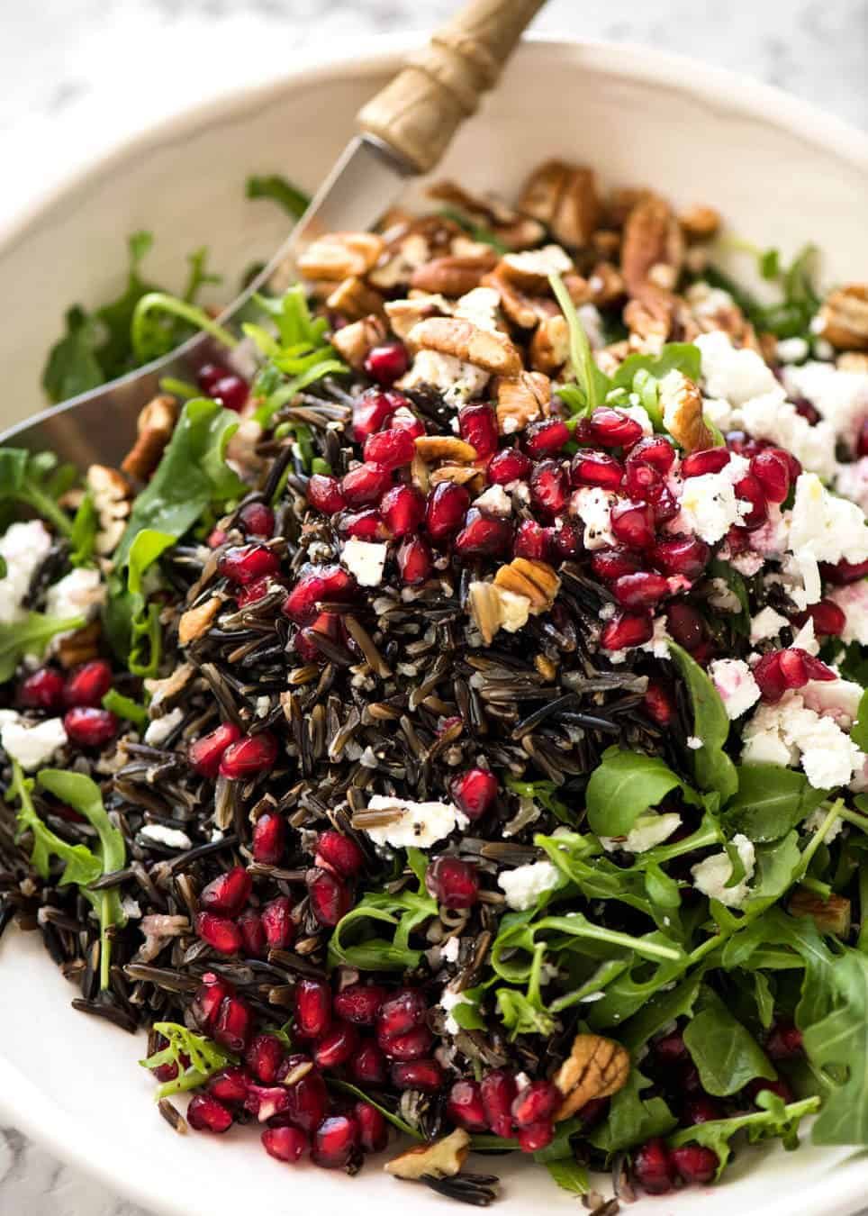 This Wild Rice Salad is a salad for celebrations! Stellar flavour combination - wild rice, pomegranate, pecans, rocket / arugula, green onions, cranberries and feta. www.recipetineats.com