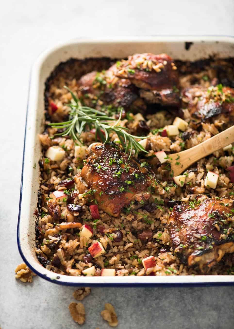 A flavour loaded one-pan, quick midweek dinner - Baked Chicken and Rice Pilaf with Cranberries, Walnuts and Apple. The smell when this is cooking is amazing! www.recipetineats.com