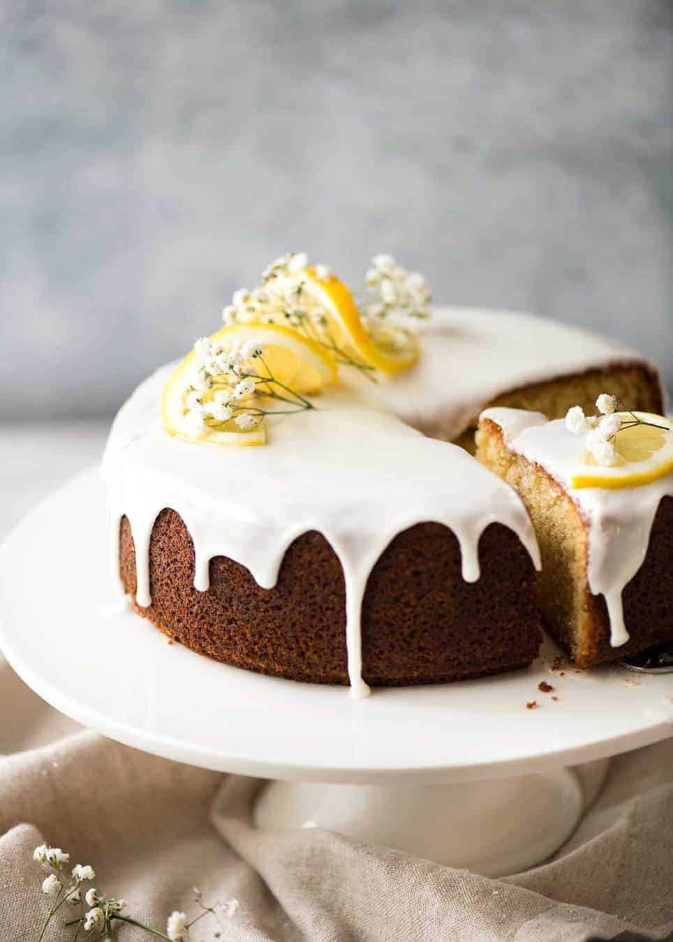 Lemon Yoghurt Cake with Drippy Lemon Glaze on a cake stand