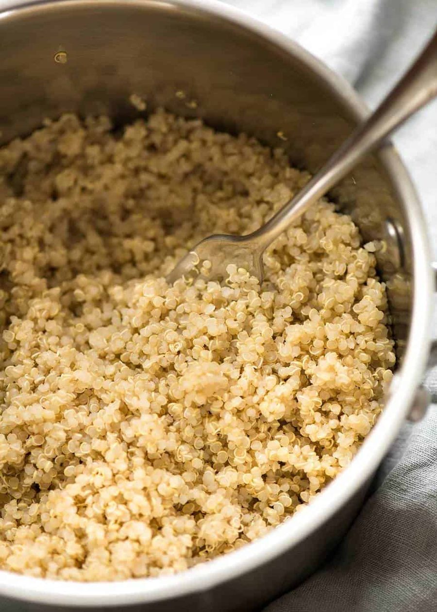 Cooked fluffy quinoa in a silver saucepan.