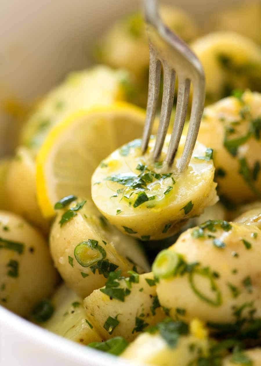 Close up of a fork picking up a no mayo Lemon Potato Salad.