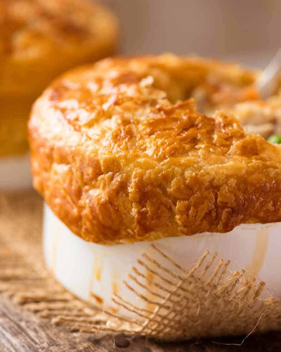 Side shot of Chicken Pot Pie in pots with puff pastry lids