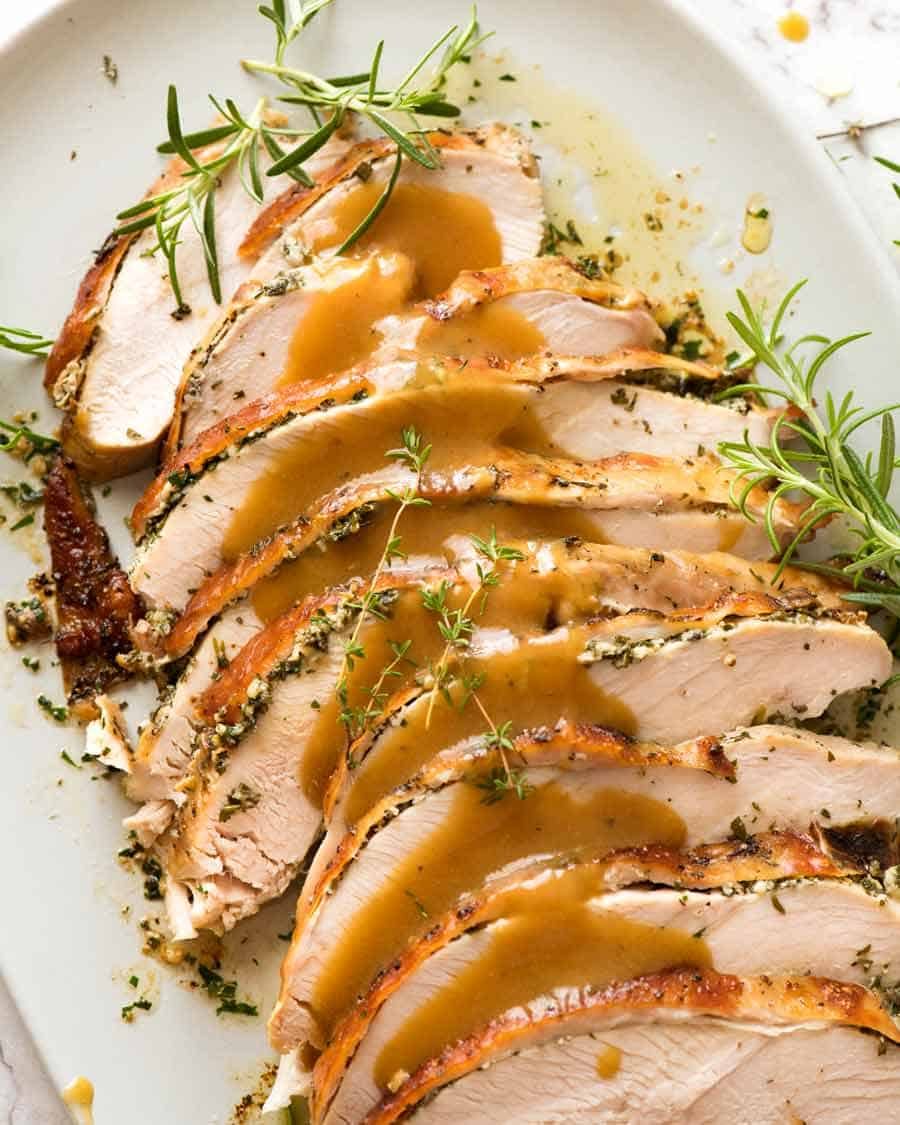 Slices of Slow Cooker Garlic Herb Turkey Breast on a plate, ready to be served