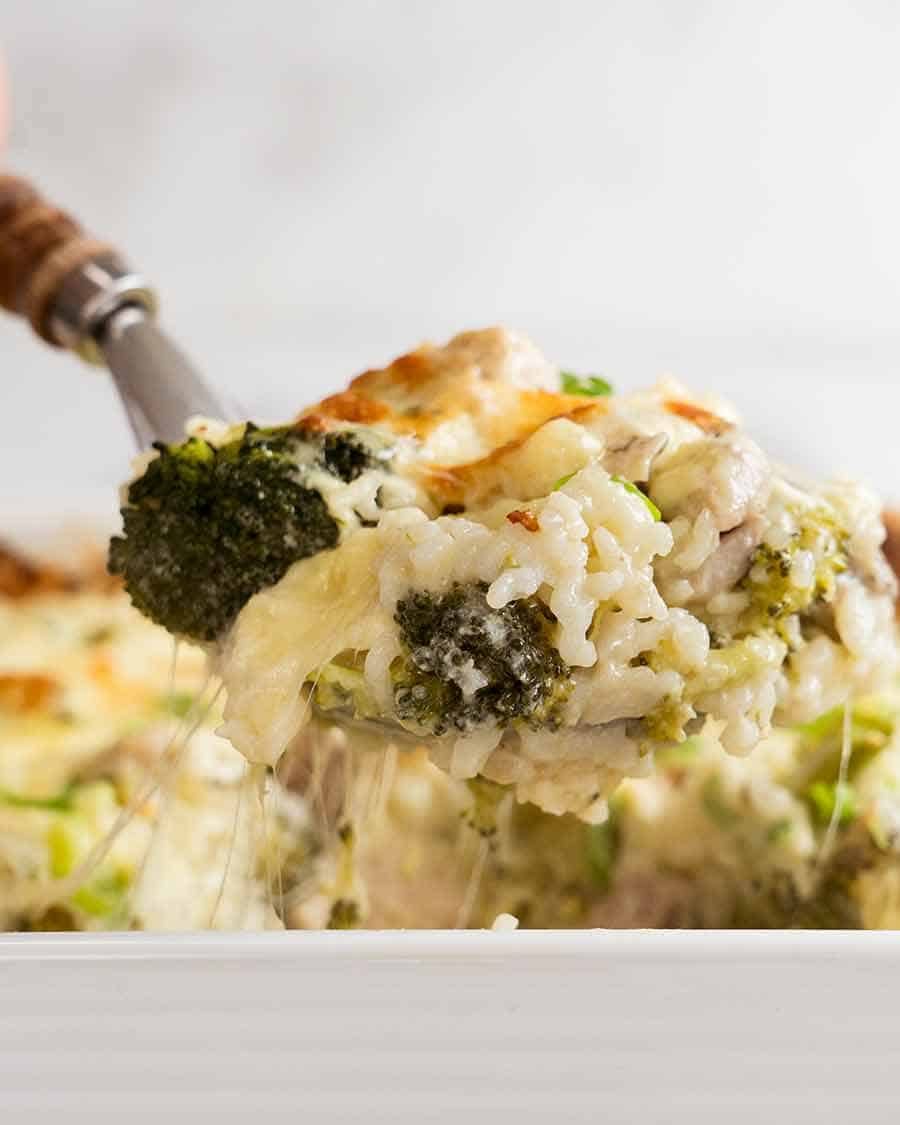 Close up of spoon scooping up creamy Chicken Rice Casserole