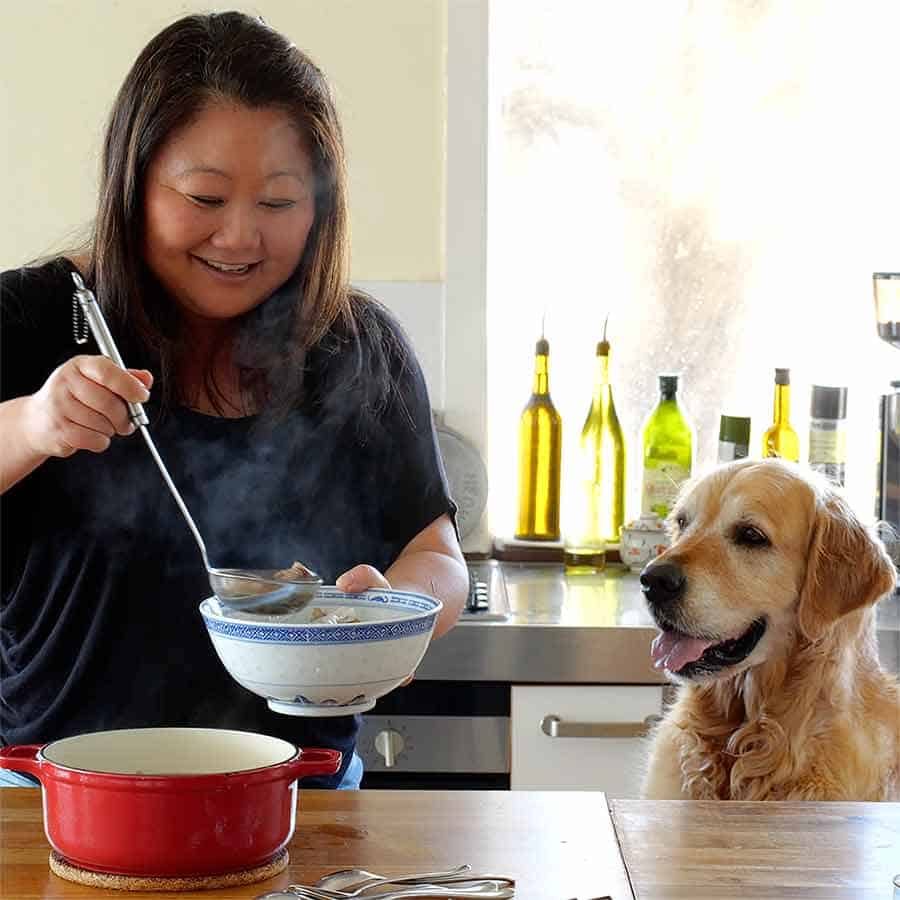 Dozer watching Nagi ladling pho into bowl