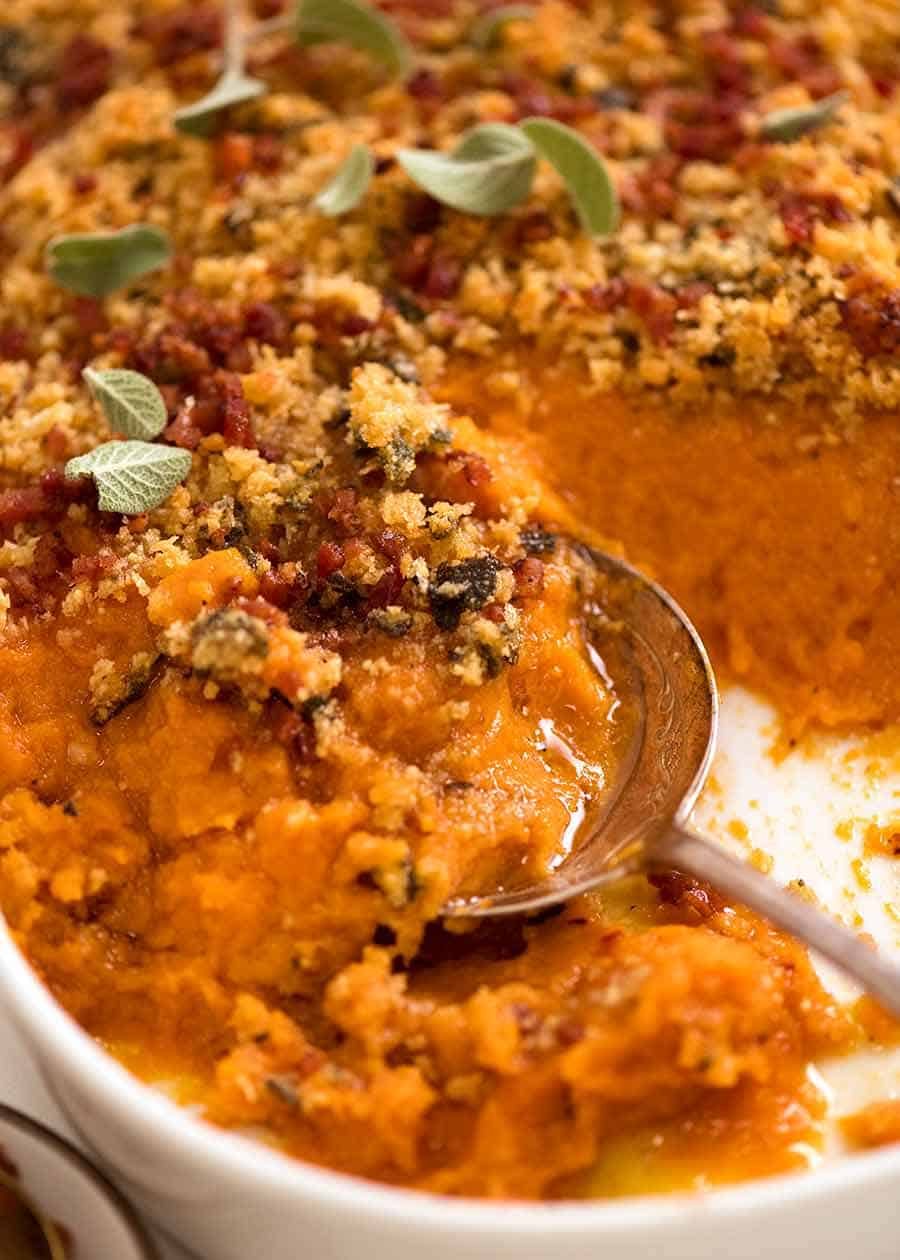 Close up of spoon serving Browned Butter Sweet Potato Casserole