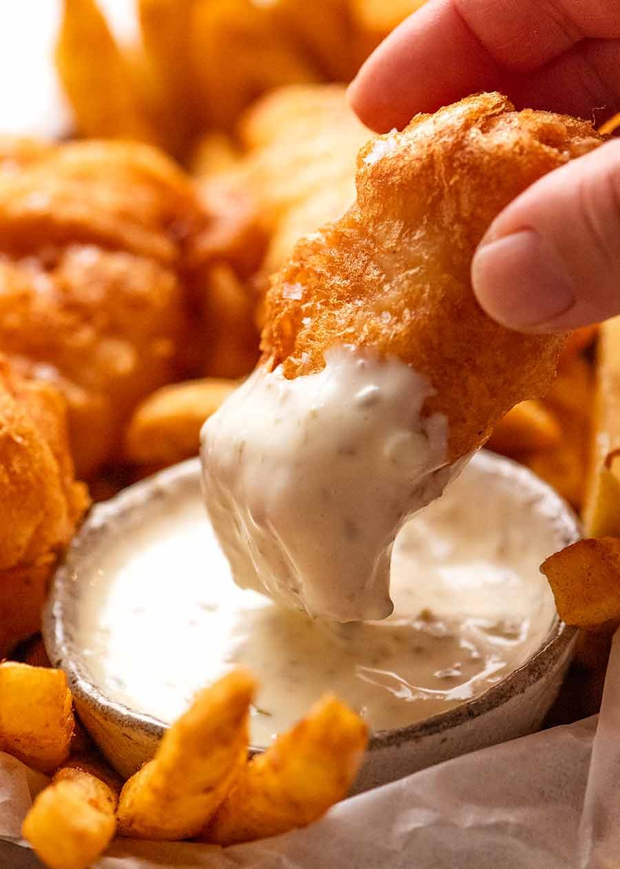 Dipping Beer Battered Fish into tartare sauce