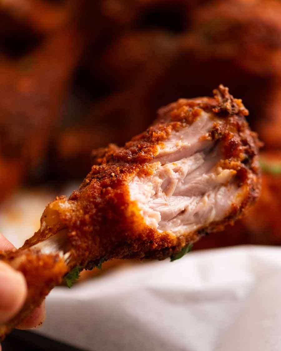 Showing the juicy inside of Crispy Baked Chicken Drumsticks