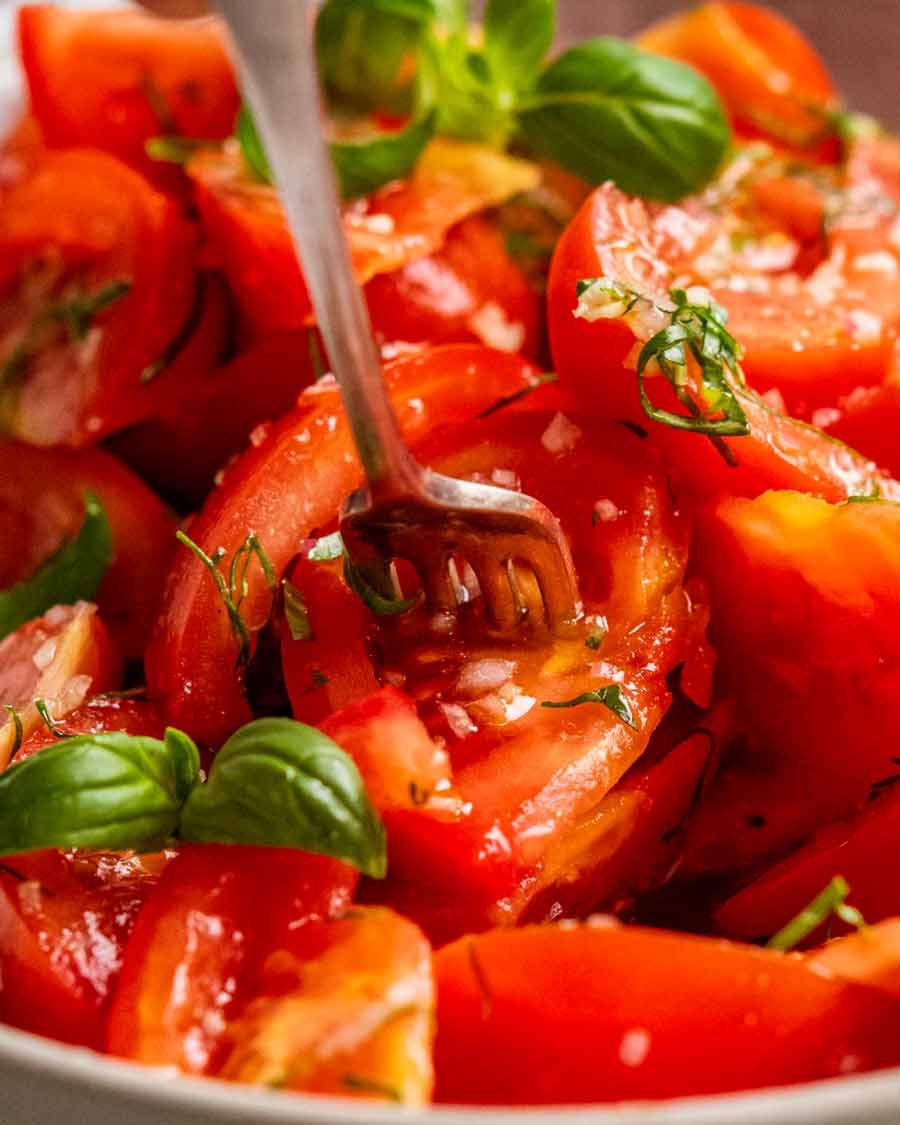 Close up of fork picking up My favourite Tomato Salad