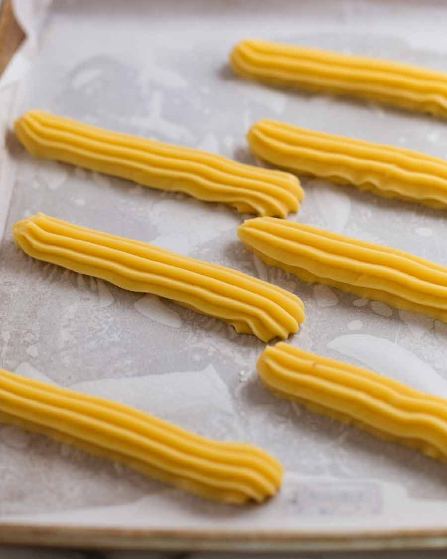 Raw piped eclairs ready to cook