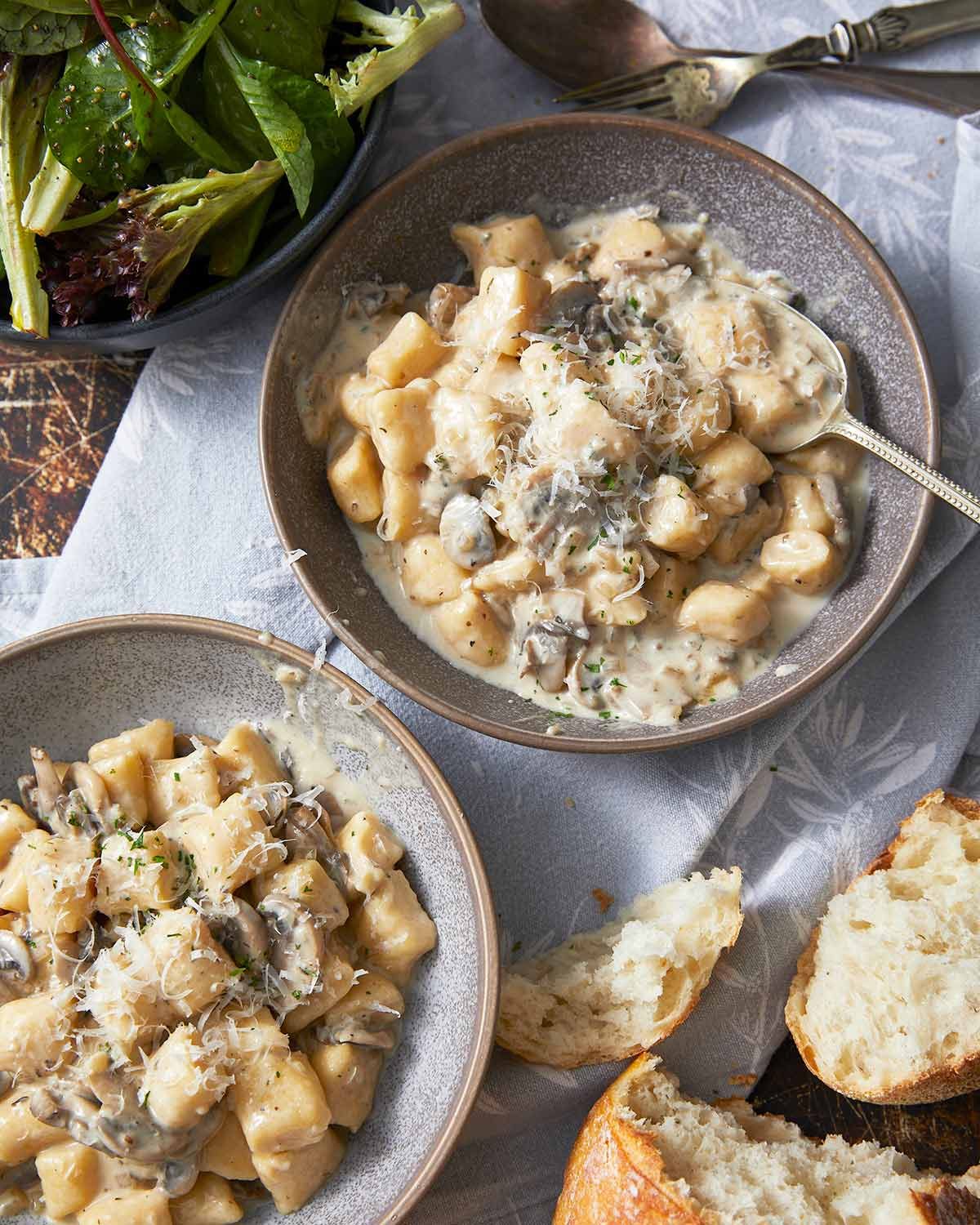Ricotta gnocchi with creamy mushroom sauce in bowls ready to eat